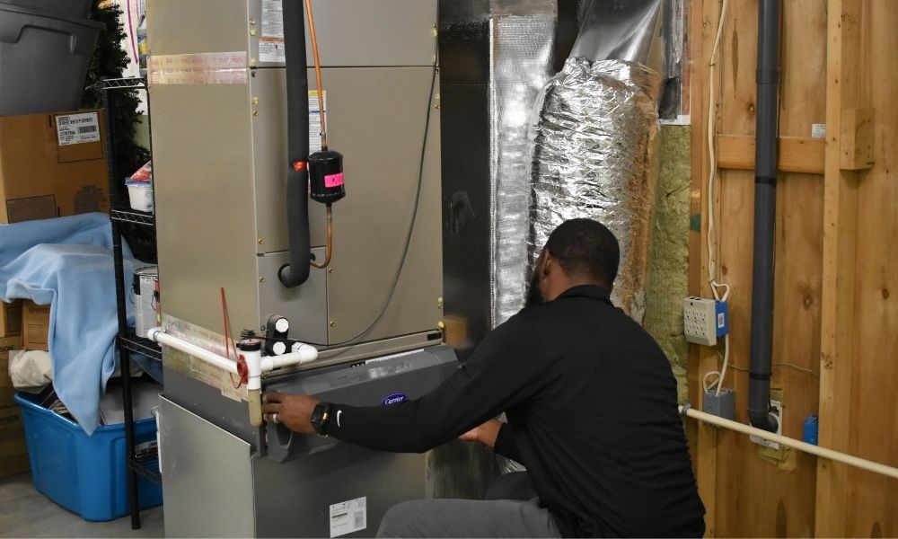 24 hour HVAC services (1) A CPS HVAC service technician performs repairs on a Carrier indoor air handler during an HVAC service call.
