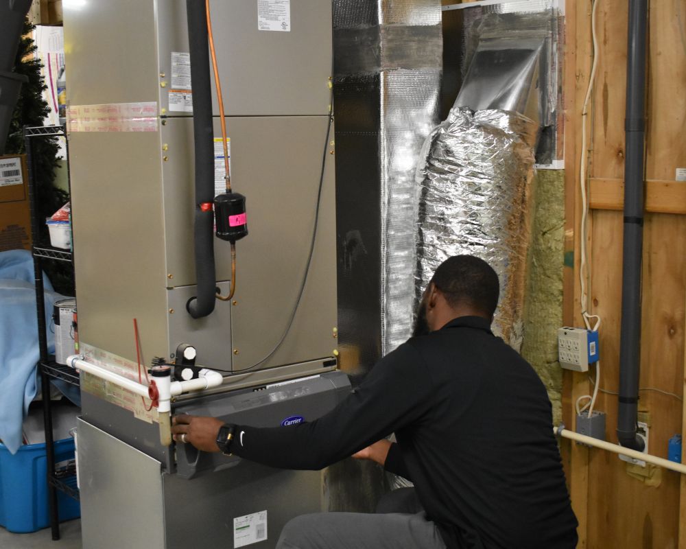 CPS team member performs emergency 24 hour HVAC repair service on a Carrier indoor air handler unit.