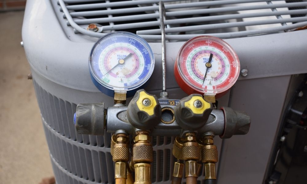 CPS HVAC services Comfort Plus HVAC services technicians check refrigerant levels during regular HVAC service and maintenance.