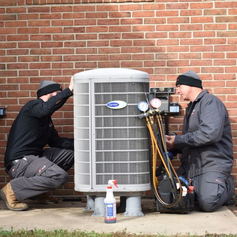 Carrier HVAC repairs CPS team members working on a Carrier HVAC unit outside a Maryland home.