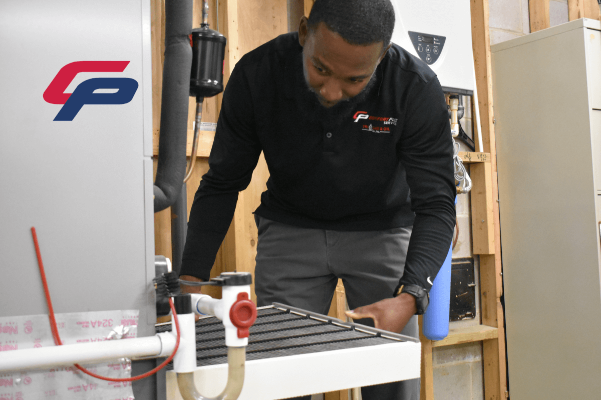 A NATE-certified HVAC technician changes an air filter during a regular service visit.