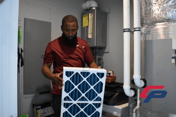 A Comfort Plus Services HVAC technician installs a new air filter during a maintenance visit to a Sussex County home.