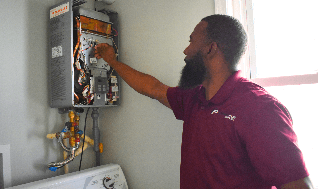 A licensed plumber performs routine tankless water heater maintenance.