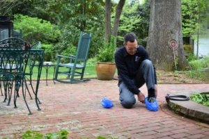 Alan D Alan D., a plumber with Comfort Plus Services, puts on shoe covers before entering a Fenwick Island home.