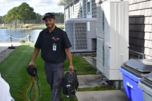 Mini-split service technician at a waterfront Delmarva vacation home.